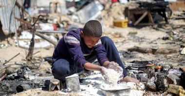 A boy salvages flour in the aftermath of an Israeli strike on a tent shelter in Khan Younis, Gaza Strip, Palestine, April 17, 2025. (AFP Photo)