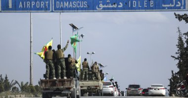 PKK/YPG terrorists stand on their vehicles as they withdraw from two neighbourhoods in Syria's northern city of Aleppo as part of a deal with the Syrian government, Aleppo, Syria, April 4, 2025. (AP Photo)