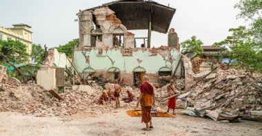 Buddhist monks dig through the rubble at a temple after a magnitude 7.7 earthquake struck Mandalay, in northern Myanmar, April 8, 2025. (AA Photo)