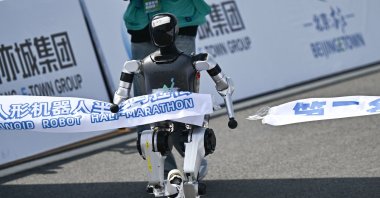  A robot crosses the finish line in the humanoid robot half marathon in Beijing, China, April 19, 2025. (AFP Photo)