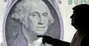 A 3D-printed miniature model depicting U.S. President Donald Trump and a representation of a U.S. dollar banknote is depicted in this illustration taken on  April 17, 2025. (Reuters Photo)