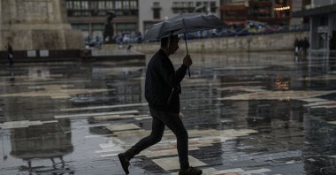 A man walks in the rain on a quiet street in Ankara, Türkiye, April 19, 2025. (AA Photo)