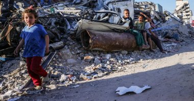 Displaced Palestinian children sit on an unexploded Israeli ordnance in Gaza City, central Gaza, Palestine, April 19, 2025. (AFP Photo)