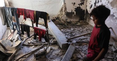 A Palestinian boy walks near unexploded ordnance, Gaza, Palestine, April 19, 2025. (AFP Photo)