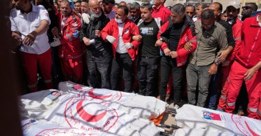 Mourners gather around the bodies of 8 Red Crescent emergency responders, recovered in Rafah a week after an Israeli attack, as they are transported for burial from a hospital, Deir al-Balah, Gaza Strip, March 31, 2025. (AP Photo)