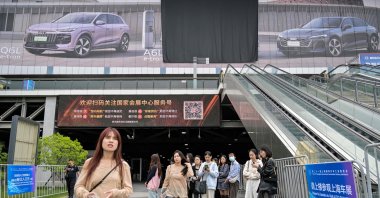People look on outside the National Exhibition and Convention Center, venue for the upcoming 21st Shanghai International Automobile Industry Exhibition, Shanghai, China, April 21, 2025. (AFP Photo)