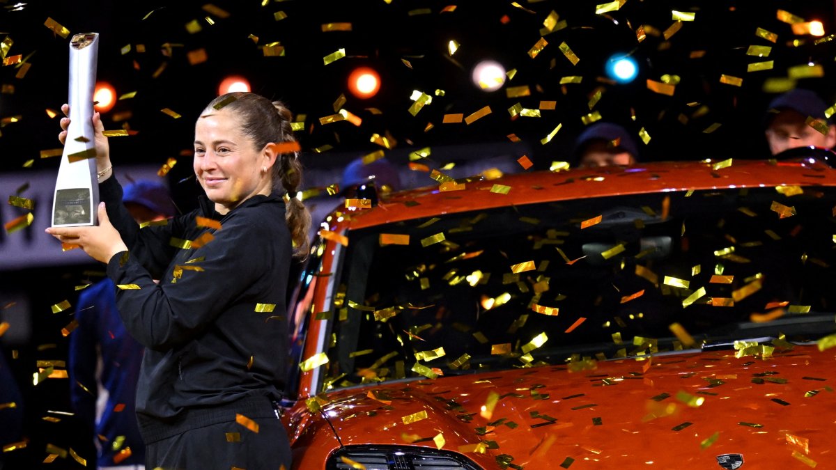 Latvia&#039;s Jelena Ostapenko poses with the trophy and the Porsche Macan Turbo as she celebrates winning the Stuttgart Tennis Grand Prix final against Belarus&#039; Aryna Sabalenka at the Porsche Arena, Stuttgart, Germany, April 21, 2025. (Reuters Photo)