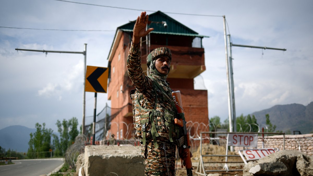 A member of Indian security personnel stands guard on a highway leading to South Kashmir's Pahalgam, following a suspected militant attack, in Marhama village, in Kashmir, April 23, 2025. REUTERS/Adnan Abidi