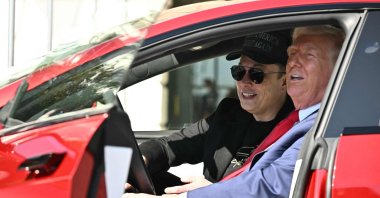 U.S. President Donald Trump and Tesla CEO Elon Musk speak to the press in a Tesla vehicle at the White House, Washington, D.C., U.S., March 11, 2025. (AFP Photo)