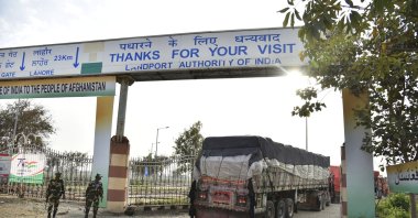 Indian Border Security Force soldiers stand guard as trucks carrying wheat from India pass through the Attari-Wagah border between India and Pakistan, near Amritsar, India, Tuesday, Feb. 22, 2022. (AP File Photo)
