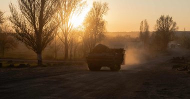 An armored Ukrainian military vehicle drives on a road in a village not far from the frontline in the Dnipropetrovsk region, April 19, 2025. (AFP Photo)