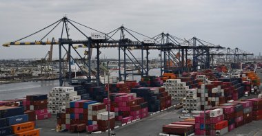 Shipping containers sit stacked as cranes unload cargo container ships at the Port of Los Angeles in San Pedro, California, U.S., April 15, 2025. (AFP Photo)
