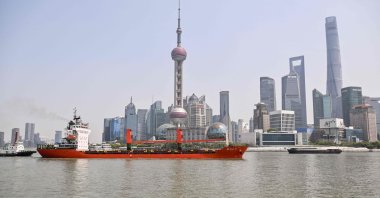 A cargo ship sails along the Huangpu River with the city&#039;s financial district seen in the background, Shanghai, China, April 8, 2025. (AFP Photo)