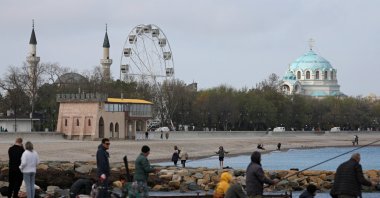People fish on an embankment in the Black Sea port city of Yevpatoriya, Crimea April 24, 2025. (Reuters Photo)