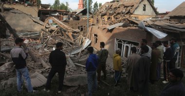 Villagers stand near the debris of demolished houses related to the family of Ahsan Ul Haq Sheikh, who officials say was involved in the Pahalgam attack, in Murran village of Pulwama, south of Srinagar, India, April 26, 2025. (EPA Photo)