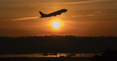 An airplane lifts off from Ronald Reagan Washington National Airport as the sun rises, Arlington, Virginia, U.S., Feb. 3, 2025. (AP Photo)