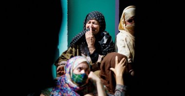 Relatives and neighbors mourn as they sit in front of the family house of Asif Sheikh, which was demolished by the Indian authorities at Monghama village in Tral, south Kashmir, April 25, 2025. (Reuters Photo)