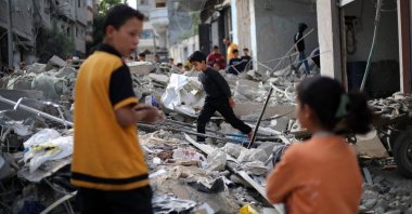 A Palestinian boy walks amid the rubble of a building destroyed in an Israeli strike at the Bureij refugee camp, central Gaza Strip, Palestine, April 27, 2025. (AFP Photo)