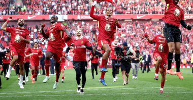 (L-R) Liverpool players Mohamed Salah, Ibrahima Konate, Caoimhin Kelleher, Virgil van Dijk and Alisson Becker celebrate in front of fans after the English Premier League match between Liverpool FC and Tottenham Hotspur, Liverpool, U.K., April 27, 2025. (EPA Photo)