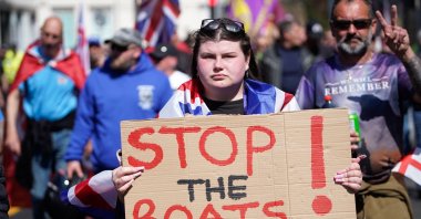 A protester holds a banner reading "Stop the Boats!" as they take part in an anti-immigration protest march, Dover, England, U.K., April 27, 2025. (AFP Photo)