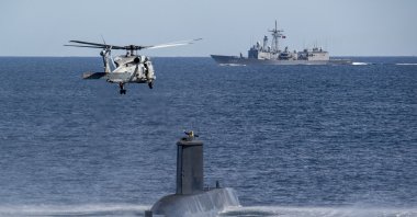 A Turkish navy helicopter, ship and submarine take part in a warfare exercise off the coast of Catania, Sicily, southern Italy, Feb. 26, 2024. (AP Photo)