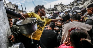 Palestinians, mostly children, wait in long lines with empty pots in hands to get food aid at the Jabalia Refugee Camp, northern Gaza City, Gaza, Palestine, April 28, 2025. (AA Photo)