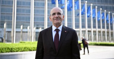 Treasury and Finance Minister Mehmet Şimşek poses for a photo after meeting EU officials, Brussels, Belgium, April 3, 2025. (AA Photo)