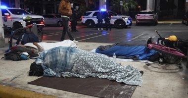 People sleep on the street during the annual Point-in-Time count of people experiencing homelessness, Miami, U.S., Jan. 24, 2025. (AP Photo)