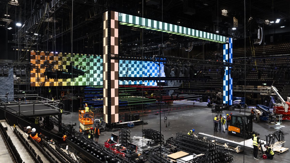 Employees work to build the main stage during a press event for the 2025 Eurovision Song Contest in the St. Jakobshalle in Basel, Switzerland, 16 April 2025. (EPA Photo)