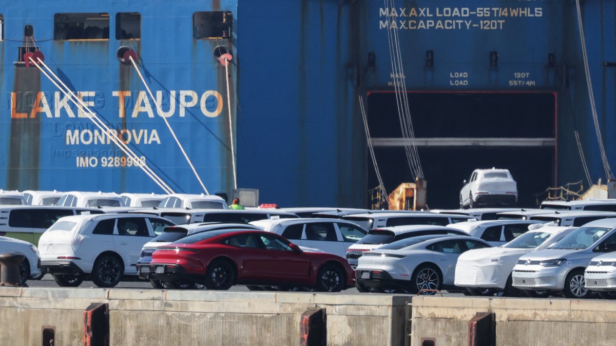A Volkswagen Group car is loaded into a cargo ship as Porsche luxury and other VW cars intended for export to the United States wait to be loaded at the seaport of Emden near the estuary, where the River Ems flows into the North Sea, in Emden, Germany, April 2, 2025. (Reuters Photo)