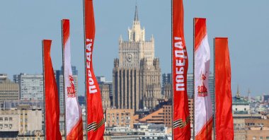 People visit the observation deck decorated for the 80th anniversary of the victory day of the Soviet Union over Nazi Germany and its allies in World War II, with the building of the Ministry of Foreign Affairs of Russia in the background, Moscow, Russia, April 28, 2025. (EPA Photo)