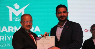 Turkish Wrestling Federation President Taha Akgül (R) poses for a photo at the Marmara Career Fair, Kocaeli, Türkiye, April 29, 2025. (DHA Photo)