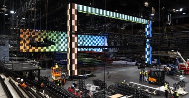 Employees work to build the main stage during a press event for the 2025 Eurovision Song Contest in the St. Jakobshalle in Basel, Switzerland, 16 April 2025. (EPA Photo)