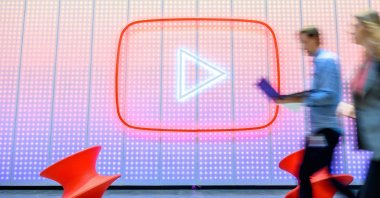People walk by a YouTube logo, as Google celebrates the 20th anniversary of first video uploaded to YouTube, at the company&#039;s corporate headquarters in San Bruno, California, U.S., April 23, 2025. (AFP Photo)