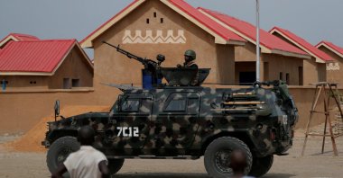 An armored vehicle of Nigerian Security Forces drives by newly built homes, ahead of the community re-opening ceremony which was destroyed by Boko Haram armed militants in 2015, in Ngarannam, Borno State, Nigeria, Oct. 21, 2022. (Reuters Photo)