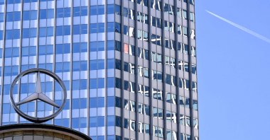A giant logo of the German automotive brand Mercedes-Benz is pictured on top of a building, Frankfurt, Germany, April 29, 2025. (AFP Photo)