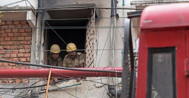 Firefighters inspect the Rituraj Hotel where a fire broke out, in Kolkata, West Bengal, India, April 30, 2025. (AFP Photo)