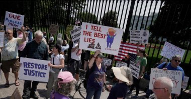 Protesters hold up signs near the White House during a Free Kilmar Abrego Garcia Now rally, Washington, U.S., May 1, 2025. (AFP Photo)