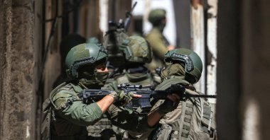 Israeli soldiers take a position during a raid in the Al-ain camp for Palestinian refugees west of Nablus in the occupied West Bank, Palestine, April 28, 2025. (AFP Photo)