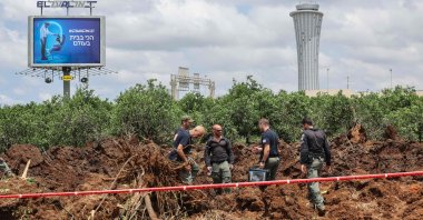Israeli security services members inspect a crater near Ben Gurion airport after a missile launched from Yemen struck the area, Tel Aviv, Israel, May 4, 2025. (AFP Photo)