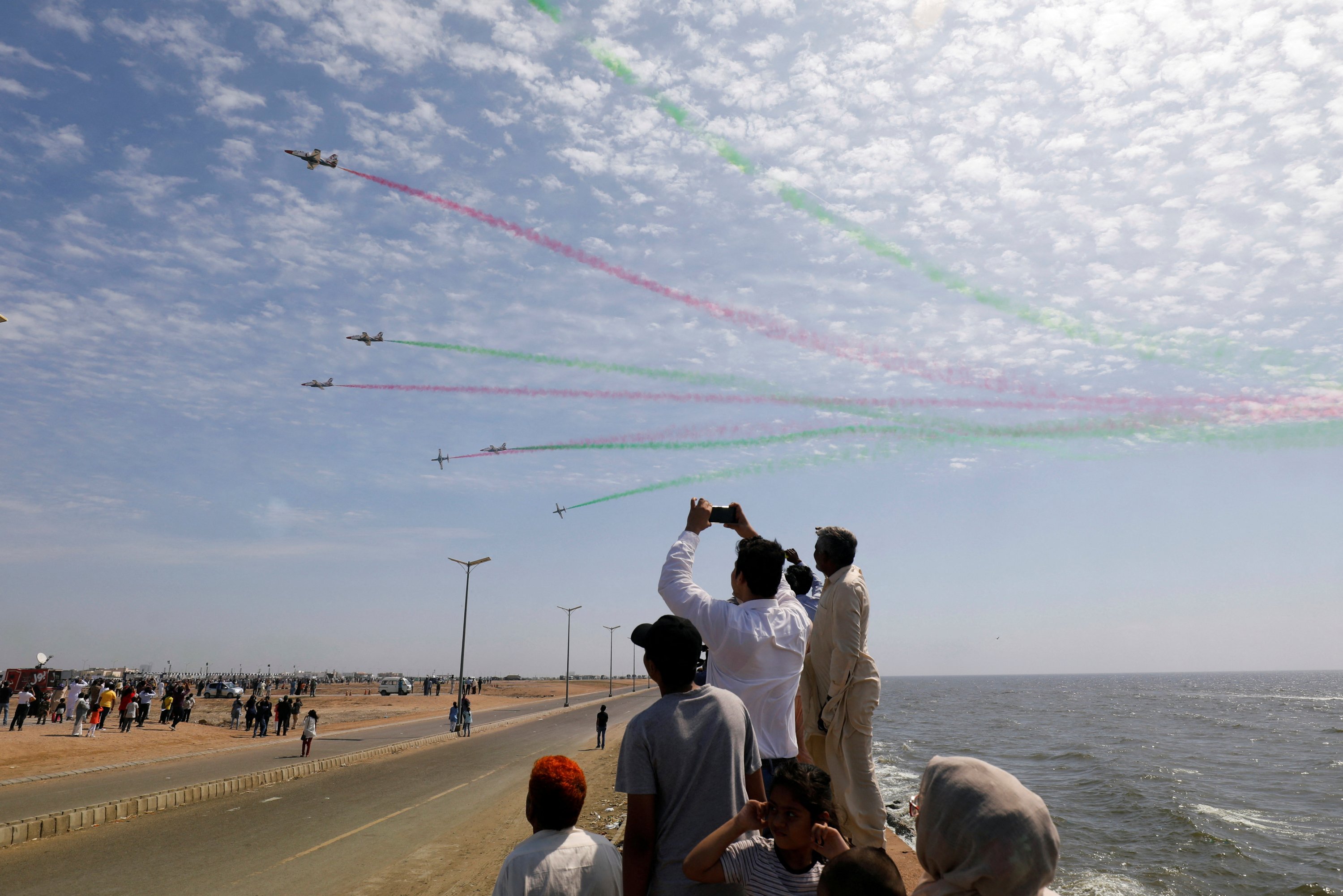 People take photos of Pakistani jets flying over Karachi, Pakistan, Feb. 27, 2020. (Reuters Photo)
