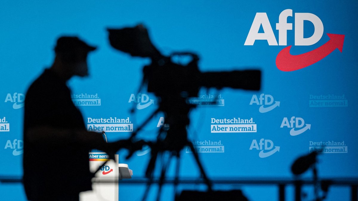A cameraman silhouettes against a wall with the AfD logo during a congress of Germany&#039;s far-right Alternative for Germany (AfD) party in Dresden, Eastern Germany, April 11, 2021. (AFP Photo)