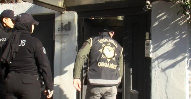 Police officers stand outside Ayşe Barım&#039;s home as they search for evidence following her detention, Istanbul, Türkiye, Jan. 24, 2025. (DHA Photo)