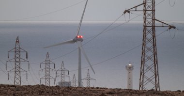 High voltage power lines and a wind turbine on Fuerteventura Island, Canary Islands, southwestern Spain, April 29, 2025. (EPA Photo)