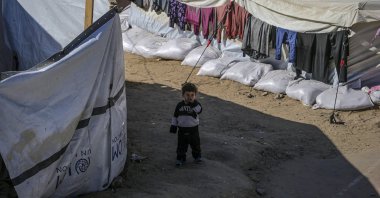 An internally displaced Palestinian child stands outside his family&#039;s tent in Al Yarmouk stadium in central Gaza City, the Gaza Strip, Palestine, May 5, 2025. (EPA Photo)