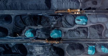 An aerial view shows machinery transferring coal at a port in Chongqing municipality, China, April 20, 2025. (AFP Photo)