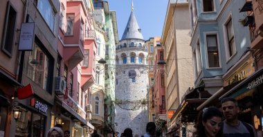 People walk on a small street that leads to the historical Galata Tower in Istanbul, Türkiye, April 25, 2025. (Reuters Photo)