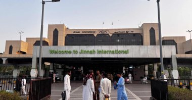Passengers wait outside at Jinnah International Airport after all domestic and international flights were cancelled in Karachi, Pakistan, May 7, 2025. (AFP Photo)