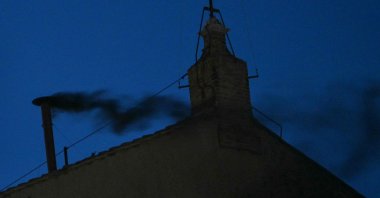 This photograph shows black smoke rising from the chimney of the Sistine Chapel signalling that cardinals failed to elect a new pope in the first ballot of their conclave in the Vatican, May 7, 2025. (AFP Photo)