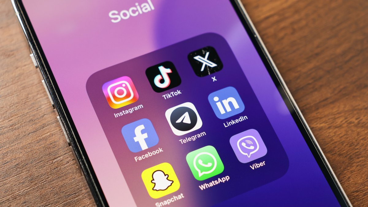 A phone screen displays popular social media apps, including Instagram, TikTok, X, Facebook, Telegram, LinkedIn, Snapchat and WhatsApp. (Shutterstock Photo)